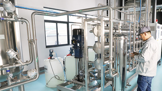 Factory water treatment system with stainless steel piping and operator inspection